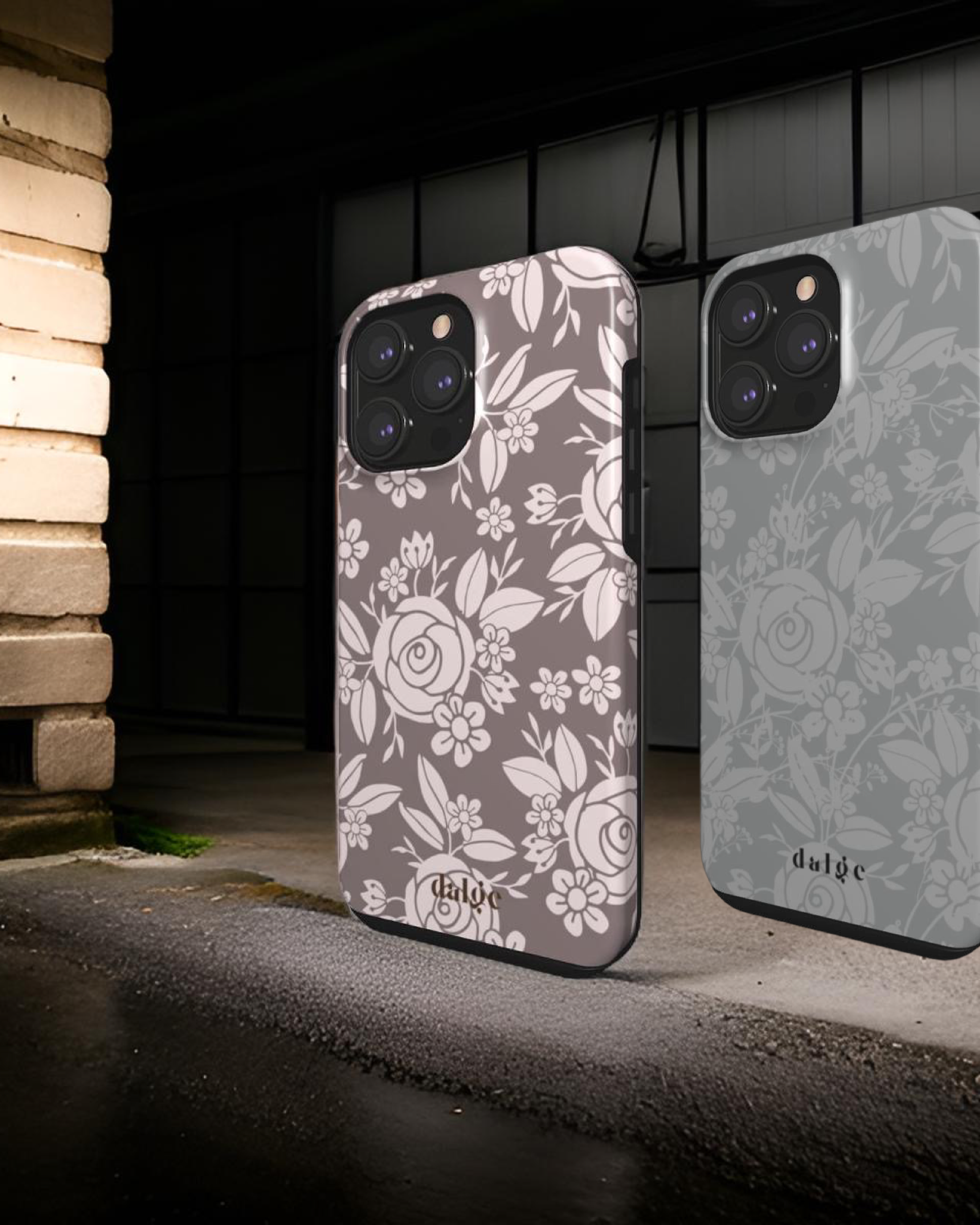 Image featuring two elegantly designed iPhone 16 cases adorned with floral patterns, displayed against an industrial-style floor and background, highlighting their stylish and modern appeal."